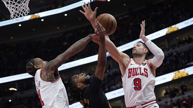 Chicago Bulls forward DeMar DeRozan (11) center Nikola Vucevic (9) defend Cleveland Cavaliers guard Darius Garland (10) during the second half at United Center.